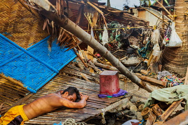 A family picture of happier times lies in the sand outside of a destroyed house on the island of Gaus on December 21, 2021 north of Ubay, Bohol, Philippines.  The impact to many of the outer lying fis...