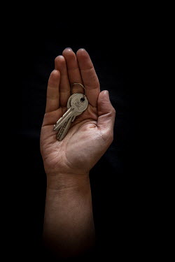 Kawther, 28, with the keys to his home in Aleppo that he fled 1 year previously. He describes his home as "warmth of family".  Syrian Nakba, Keys of home. The front-door keys to the homes of some of t...