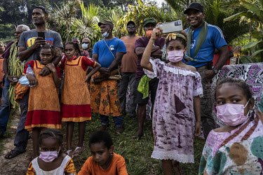Jacques Atti (42), from the Touaourou Tribe (left), reacts with his nieces and other relatives as his bride, Sabrina Manique (42), from Lifou Island, arrives with her clan's marriage delegation and pe...
