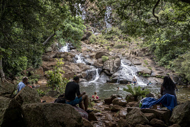 Day trippers picnic at a waterfall on tribal land Goro.