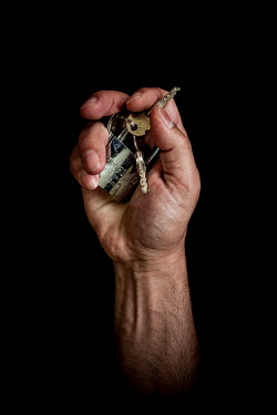 Mohanad, 43, with the keys to his home in Damascus that he fled 2 years, 10 months previously. He describes his home as "Just a space in a nice place".  Syrian Nakba, Keys of home. The front-door keys...