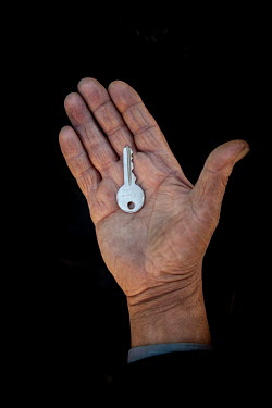 Safwan, 60, with the keys to his home in Aleppo that he fled 1 year previously. He describes his home as "My country is my home".  Syrian Nakba, Keys of home. The front-door keys to the homes of some...