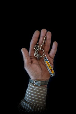Abu Omar, 40, with the keys to his home in Aleppo that he fled 3 months previously. He describes his home as "I lost my family, so it means nothing".  Syrian Nakba, Keys of home. The front-door keys t...