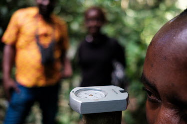 A participant practicing reading a compass during a wood biology workshop in the forest at the Yangambi research station. The workshop was a FORETS project initiative for traders, harvesters or users...