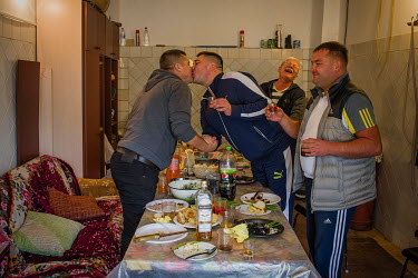 Men kissing during a birthday party. In the Russian culture men kisses on the lips, although this is not a day to day custom