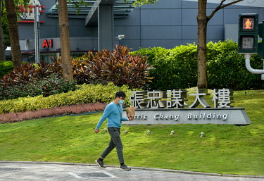 A man walks in front of the Morris Chang Building, at the HQ of Taiwan Semiconductor Manufacturing (TSMC) in Hsinchu Science Park.
