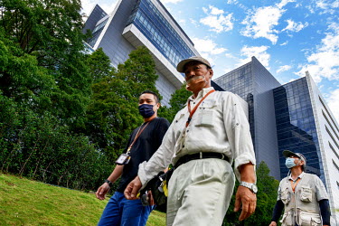 Workers walk past the Taiwan Semiconductor Manufacturing (TSMC) Museum of Innovation building in Hsinchu Science Park.