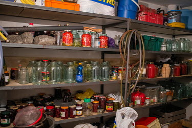 Shelves crammed with jars and preserved foods.