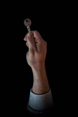 Taher, 29, with the keys to his home in Raqqah that he fled 1.5 months previously. He describes his home as "we are here now, but our hearts are there".  Syrian Nakba, Keys of home. The front-door key...