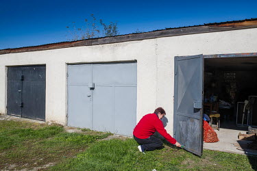 A woman painting a garage door.