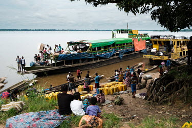 Barges unloading people and goods along the banks of the River Congo on market day.