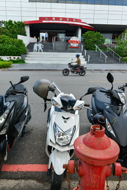Scooters parked at the entrance of the Taiwan Semiconductor Manufacturing (TSMC) Museum of Innovation in Hsinchu Science Park.