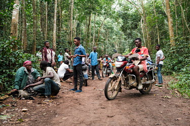 Lisasi Bolongola (left) haggles with a trader over the sale price of a monkey at a bushmeat market at a crossroads of forest tracks in Yangambi. As hunters emerge from the bush on Saturdays after a we...