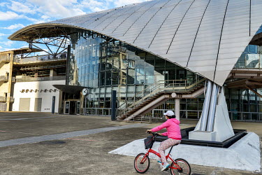 A bicyclist passes the Hsinchu HSR (High Speed Rail) Station.