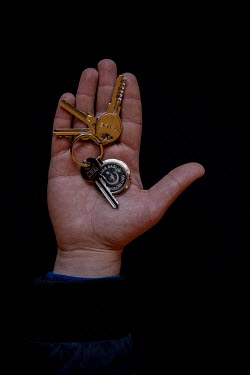 Anas, 24, with the keys to his home in Binnish, Idlib, that he fled 1 year and 5 months previously. He describes his home as ^memories, life, friends and family^.Syrian Nakba, Keys of home.The front-d...