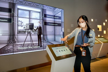 A member of staff explains an exhibit during a guided tour of the Taiwan Semiconductor Manufacturing (TSMC) Museum of Innovation in Hsinchu Science Park.