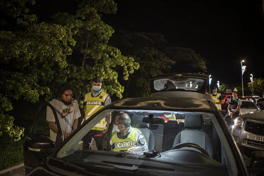 Gendarmerie officers question and breathalyse drivers at a checkpoint during an anti-crime, drink-driving operation during a curfew just a week ahead of the independence referendum.