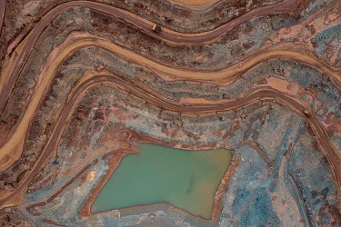 Aerial overview of the mine site where mine trucks load with ore at the Prony Resources nickel mine.