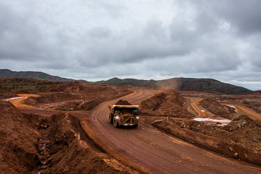 Trucks transport ore at the Prony Resources Nickel Mine.