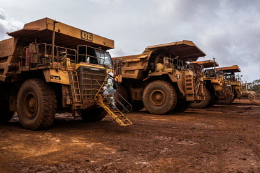 Truck drivers walk to their vehicles at the beginning of their shift at the Prony Resources Nickel Mine.