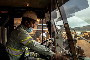 A 'Kanak' truck driver prepares his vehicle at the beginning of his shift at the Prony Resources Nickel Mine.