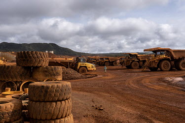 Truck drivers walk to their vehicles at the beginning of their shift at the Prony Resources Nickel Mine.