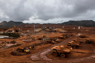 Trucks transport ore at the Prony Resources Nickel Mine.