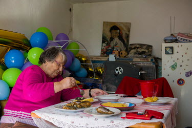 A woman is enjoying a freshly prepared meal inside a garage.