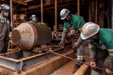 Plant workers repairing a motor at the nickel processing plant at Prony Resources nickel mine.