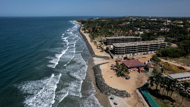Hotels on Senegambia beach are trying to protect themselves from the rising waters due to climate change by building rock dikes facing the sea.