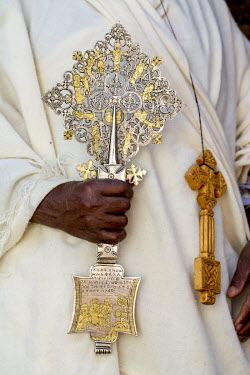 A priest holds the cross of the Narga Sellaisie church.