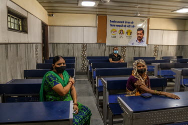 People wait inside an observation room after getting a dose of Covishield (AstraZeneca), a COVID-19 vaccine, at a health centre in the city.