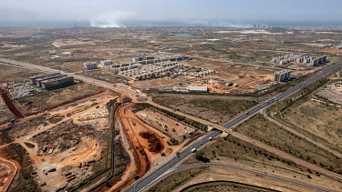 An aerial view of Diamniadio, a new city being built near Dakar. Diamniadio is cut in two by a motorway which is crossed by a single bridge.