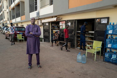 Seydina Amza Toure, outside a shop in Senegindia's SD City residential and commercial complex in Diamniadio, a new city being built near Dakar.