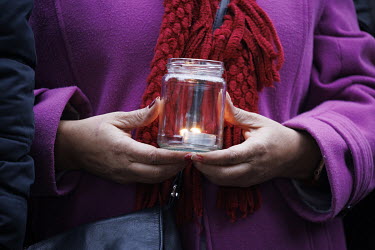 A woman holds a candle at a vigil in Mountsfield Park to mark what would have been Ella Kissi Debrah's 18th birthday, if she hadn't died from an asthma attack brought on by air pollution. Her mother R...