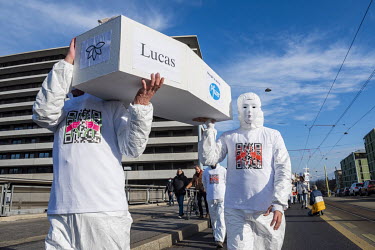 Demonstration against Covid 19 vaccination and masks for children. The masked cortege carried white coffins with childrens' names and 'brought to you by Pfizer' emblazoned on them evoking children kil...