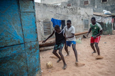 Youths playing football in the fishermen's quarter.