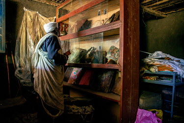 A priest with religious objects at Debre Mariam church