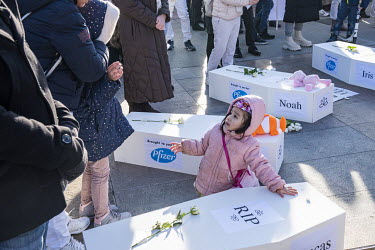 Demonstration arriving at the Place des Nations outside the UN against Covid 19 vaccination. The cortege carried white coffins with childrens' names and 'brought to you by Pfizer' emblazoned on them e...