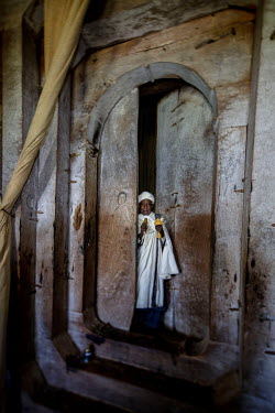 A priest stands in the doorway at Debre Mariam church.