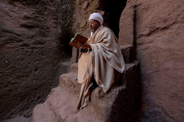 A priest reads passages of the Ethiopian bible near the Tomb of Adam.