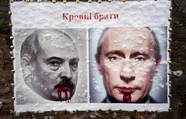 A poster of Lukashenko and Putin which reads: ^Blood Brothers^, on a wall next to the 'All for Victory' tent. The tent was installed in front of the Kharkiv Regional State Administration in September...