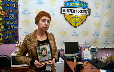 Natalia Mishenko (56) a volunteer at the Association of Relatives of Missing and Deceased Defenders of Ukraine holds a photo of her son Micenko Sergiy Volodimirovich who was killed in 2017. He was 28...