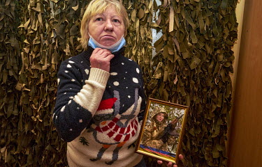 Valentina Anisimova holds a photo of her daughter Ganna Valeriivna, a doctor, who was killed in 2014 aged 24. Valentina said that volunteers of Association of Relatives of Missing and Deceased Defende...