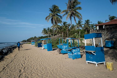 Closed hawker's stalls on a hotel beach in Senegambia. Hotels there are trying to protect themselves from the rising waters due to climate change by building rock dikes facing the sea.