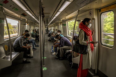 Commuters on a metro train after services resumed at 50 percent capacity following the easing of the COVID-19 lockdown as infections across the country fell to a two month low.
