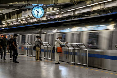 Commuters at a metro station after services resumed at 50 percent capacity following the easing of the COVID-19 lockdown as infections across the country fell to a two month low.
