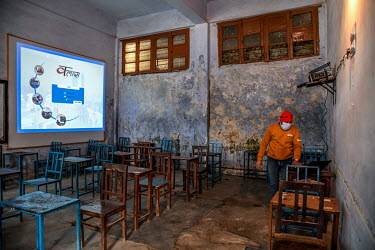 A teacher doing an online lesson from an empty classroom in one a government schools closed due to COVID-19 restrictions.