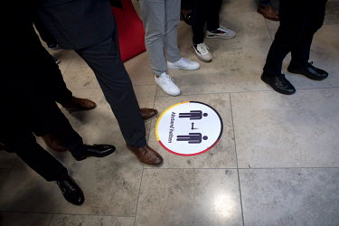 People ignoring a social distancing instruction sticker on the floor of the CDU's headquarters Konrad Adenauer Haus during federal parliamentary elections.