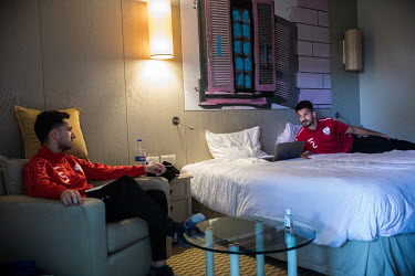 Adam Najm (L) and David Najm (R), brothers who both play for the Afghanistan national football team, relax in their hotel room prior to their international friendly match against Indonesia.